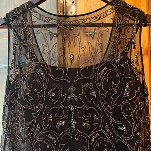 Stunning black silk formal dress with intricate beadwork.